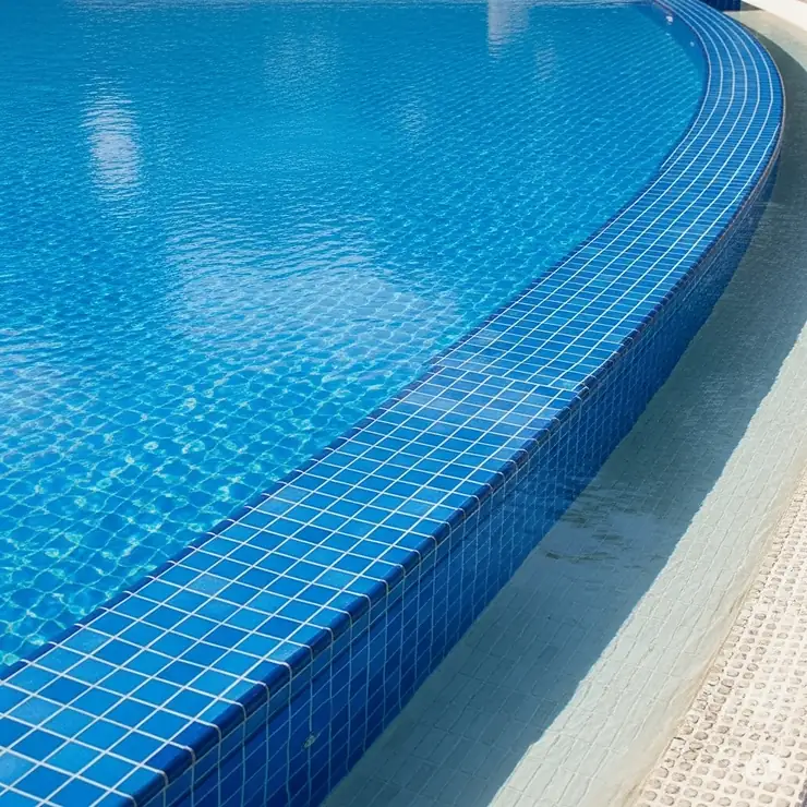 A clean, empty swimming pool with focus on the tile line.