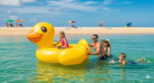 A giant inflatable duck float being used by a family at the beach, providing a fun and relaxing water activity.