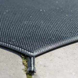 Texture close-up of the tightly woven, high-strength fabric of a heavy-duty mesh pool cover, emphasizing long-lasting durability.