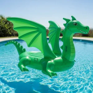 A majestic green inflatable dragon pool float with outstretched wings and a long tail, floating in a sparkling blue swimming pool on a sunny day.