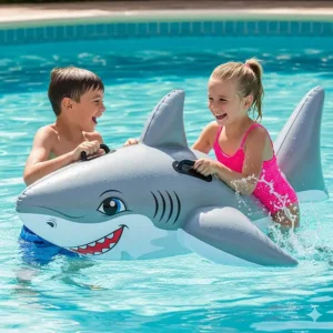 Two excited children holding onto a durable, inflatable shark pool float as they play together in the water, showing the float's size and handles.