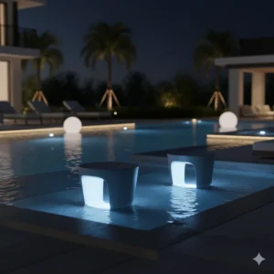 Sleek, modern pool stools in a dark color illuminated by integrated LED lighting for a resort-style look at night.