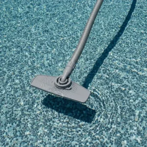 A tangle-free swivel hose for a pool vacuum, a key feature that helps the cleaner navigate freely over the bumpy surface of a Pebble Tec pool.