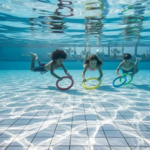 A clear photo of colorful dive rings scattered on the pool floor, ready for a treasure hunt swimming pool game or dive challenge.