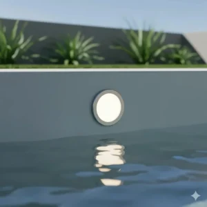 A modern, flush-mounted nicheless underwater light for a seamless look in a concrete inground pool.