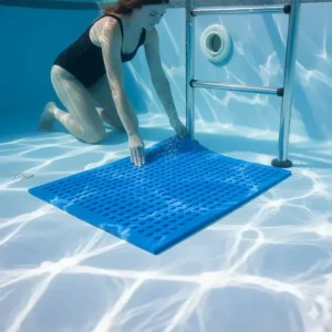 Image of a hand positioning a heavy-duty pool ladder mat at the bottom of the pool before the ladder is set up.