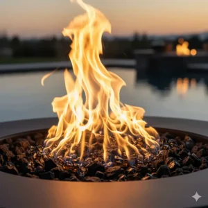 Detailed shot of a large, controlled propane gas flame burning in a high-quality pool fire bowl, showcasing the dazzling fire media.
