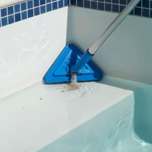 Triangular pool vacuum head specifically designed to effectively reach and clean tight corners and steps.