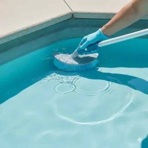 The unique curved design of a pool brush head, perfect for reaching and cleaning tough-to-reach corners and steps in a vinyl liner pool.