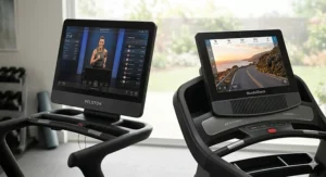 Close-up comparison of the Peloton 23.8-inch HD touchscreen versus the NordicTrack rotating tilt display.