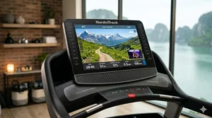 The iFIT digital interface on a NordicTrack treadmill screen showing a scenic outdoor running trail in Switzerland.