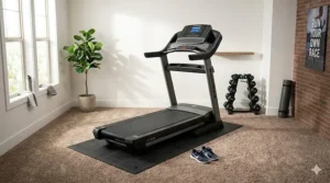A sleek motorized running machine neatly placed on a non-slip treadmill mat for carpet in a bright s