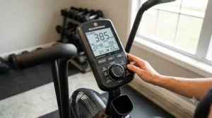 A close-up of a digital console on a top-rated air bike showing workout metrics like calories burned and heart rate.
