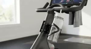Water bottle cage mount securely attached to a Peloton bike frame for easy hydration access
