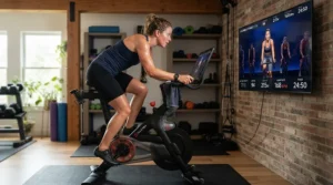 Instructor on screen leading a rider through a steep climb on an interactive exercise bike