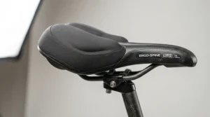 Close-up of an ergonomic exercise bike seat designed with targeted lumbar support for comfortable indoor cycling workouts